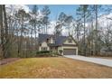 Charming single-Gathering home with an attached garage, long driveway, and beautifully maintained lawn at 2845 Hickory Cir, Snellville, GA 30078