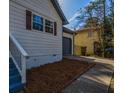 Side view showcasing the driveway and siding details at 40 Cumberland Dr, Rex, GA 30273