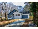 Lovely home featuring a one-car garage, driveway, and manicured front lawn with mature trees at 40 Cumberland Dr, Rex, GA 30273