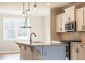 Bright kitchen with a large center island, modern appliances, and ample cabinet space at 4818 Floydwood Ln, Mableton, GA 30126