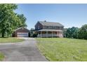 Charming two-story brick home featuring a welcoming front porch and a detached garage at 4840 Pisgah Rd, Cumming, GA 30028