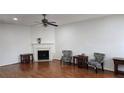 Spacious living room featuring hardwood floors, a fireplace, and neutral paint at 553 Rockbridge Trl, Stone Mountain, GA 30083