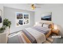 Bright bedroom featuring a large window, a bed with gray bedding, and stylish decor at 1110 Robert Pointe Way, Lawrenceville, GA 30045