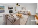 Bright living room features neutral tones, comfortable seating, and stylish decor at 1110 Robert Pointe Way, Lawrenceville, GA 30045