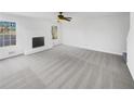 Bright living room with new carpet, a fireplace, and lots of light from the windows showcasing serene views at 1110 Robert Pointe Way, Lawrenceville, GA 30045