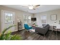 Cozy living room with dark floors, bright natural light, comfortable furnishings, and a ceiling fan at 1584 Carroll Nw Dr, Atlanta, GA 30318