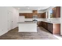 Well-lit kitchen features stainless appliances, granite counters, a white subway tile backsplash, and a center island at 205 Groveton Ct, Euharlee, GA 30145