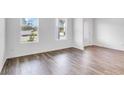Bright living room with stylish flooring and large windows, creating a warm atmosphere at 205 Groveton Ct, Euharlee, GA 30145