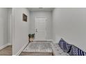 Inviting entryway with neutral walls, stylish rug, and bench seating at 811 Pineberry Ct, Grayson, GA 30017