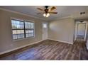 Bright and airy living room featuring stylish hardwood floors and a large window at 11 Grove Ln, Hampton, GA 30228
