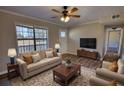 Comfortable living room with a cozy sofa, armchairs, and large window letting in natural light at 11 Grove Ln, Hampton, GA 30228