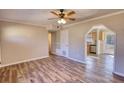 Open-concept living room with new hardwood flooring and an archway to the kitchen at 11 Grove Ln, Hampton, GA 30228