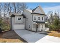 Stylish two-story home with a long driveway, attached garage, and inviting front porch at 2150 Essex Sw Ave, Atlanta, GA 30311