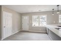 Bright living space featuring a front door, large window, and light-colored hardwood flooring at 2945 Catalina Dr, Decatur, GA 30032