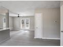 An open living area with a ceiling fan, a door leading to a deck, and neutral-colored walls at 2945 Catalina Dr, Decatur, GA 30032