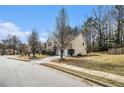 Inviting home exterior on a corner lot surrounded by lush trees and grass in a quiet neighborhood at 5803 Star Flower Dr, Ellenwood, GA 30294