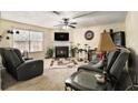 Comfortable living room featuring a fireplace, plush seating, and natural light from the window at 5803 Star Flower Dr, Ellenwood, GA 30294
