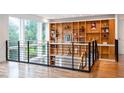 Stylish landing with built-in shelves, metal railing, and hardwood floors at 755 Adair Ne Ave, Atlanta, GA 30306