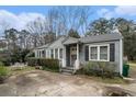 Charming single-story home with blue siding and landscaped front yard and an inviting front porch at 1054 Shepherds Ne Ln, Atlanta, GA 30324