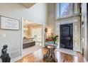 Inviting foyer with high ceilings, decorative glass door and an ornate glass entry table at 1300 Village Oaks Ln, Lawrenceville, GA 30043