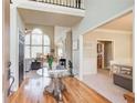Spacious foyer featuring wood floors, an elegant glass table, and views of the living room at 1300 Village Oaks Ln, Lawrenceville, GA 30043