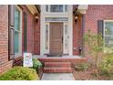 Close-up view of the brick front entrance, showing the front door and surrounding details at 1300 Village Oaks Ln, Lawrenceville, GA 30043