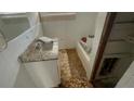 Bathroom with a tiled shower/tub combo and a granite vanity at 2317 Sheryl Dr, Decatur, GA 30032