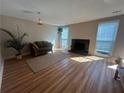 Spacious living room featuring hardwood floors, a fireplace, and natural light at 1063 Riverbend Club Se Dr, Atlanta, GA 30339