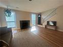 View of the living room showing the fireplace, staircase, and multiple windows at 1063 Riverbend Club Se Dr, Atlanta, GA 30339
