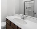 Bathroom featuring a modern vanity, sleek faucet, a framed mirror, and a walk-in shower at 1745 Lansmere Sw St, Marietta, GA 30008