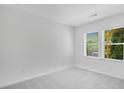 Bright bedroom featuring two windows with a view, neutral carpet, and ample natural light at 1745 Lansmere Sw St, Marietta, GA 30008