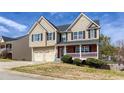 Lovely two-story home with well-maintained landscaping, brick porch, and a convenient two-car garage at 203 Overlook Ct, Dallas, GA 30157