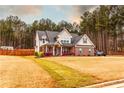 Beautiful two-story home with a well-maintained lawn and mature trees offering privacy at 35 Rock Rose Dr, Covington, GA 30014