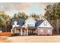 Attractive two-story home boasting a brick facade, gray shutters, and manicured greenery at 35 Rock Rose Dr, Covington, GA 30014