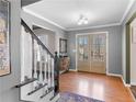 Inviting foyer with hardwood floors, staircase, and double doors leading to the outside at 526 Lakeside Dr, Hiram, GA 30141
