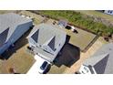 Aerial view showcases the property's fenced backyard, and proximity to neighboring homes, in a planned community at 60 Cottontail Lane, Villa Rica, GA 30180