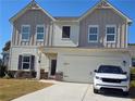 Charming two-story home with a two-car garage, manicured lawn, and inviting curb appeal in a Gathering-friendly neighborhood at 60 Cottontail Ln, Villa Rica, GA 30180