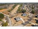 An aerial view of the property shows its location on a tree-lined street within a well-planned community at 6801 Louis Dr, Locust Grove, GA 30248