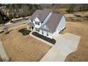 An aerial view reveals the home's large driveway, manicured landscaping, and well-maintained lawn at 6801 Louis Dr, Locust Grove, GA 30248