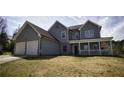 Traditional two-story home with a two-car garage, covered porch, and well-maintained lawn at 70 Woodcliff Way, Covington, GA 30014