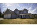 Two-story home with a covered porch and attached two-car garage at 70 Woodcliff Way, Covington, GA 30014