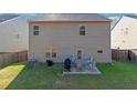 A fenced backyard with a small patio set and some outdoor furniture at 1152 Werre Way, Locust Grove, GA 30248