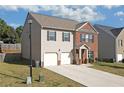 Side view of a two-story home showing the driveway and a partial view of the backyard at 1152 Werre Way, Locust Grove, GA 30248