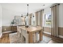 Elegant dining room with wood floors, stylish lighting, and a large window at 1654 Tide Mill Rd, Cumming, GA 30040