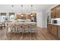 Modern kitchen featuring a large island, stainless steel appliances, and wood flooring at 1654 Tide Mill Rd, Cumming, GA 30040