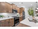 Bright kitchen featuring stainless steel appliances, white countertops, and modern cabinetry at 1654 Tide Mill Rd, Cumming, GA 30040