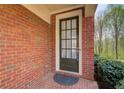 Stylish front door with glass panels, set in a brick facade at 1111 Newpark View Pl, Mableton, GA 30126