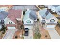 Aerial view of houses with well-manicured lawns and mature trees at 11169 James Madison Dr, Hampton, GA 30228