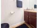 Bathroom features vanity with a brown cabinet and decorative bottles at 11169 James Madison Dr, Hampton, GA 30228