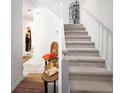 Bright staircase featuring white railing and neutral carpet with decor at 11169 James Madison Dr, Hampton, GA 30228